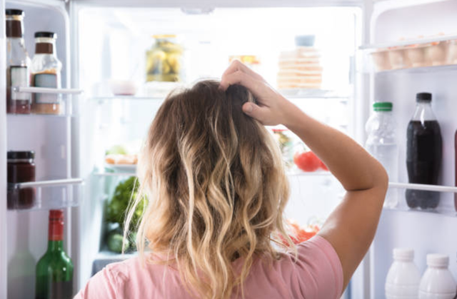 woman in front of refrigerator